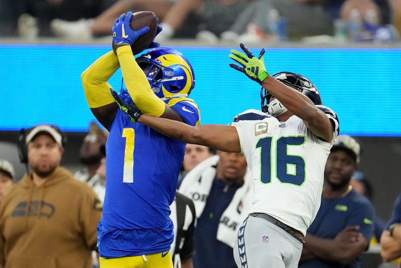 Nov 19, 2023; Inglewood, California, USA; Los Angeles Rams cornerback Derion Kendrick (1) makes a catch against Seattle Seahawks wide receiver Tyler Lockett (16) in the fourth quarter at SoFi Stadium. Mandatory Credit: Kirby Lee-USA TODAY Sports