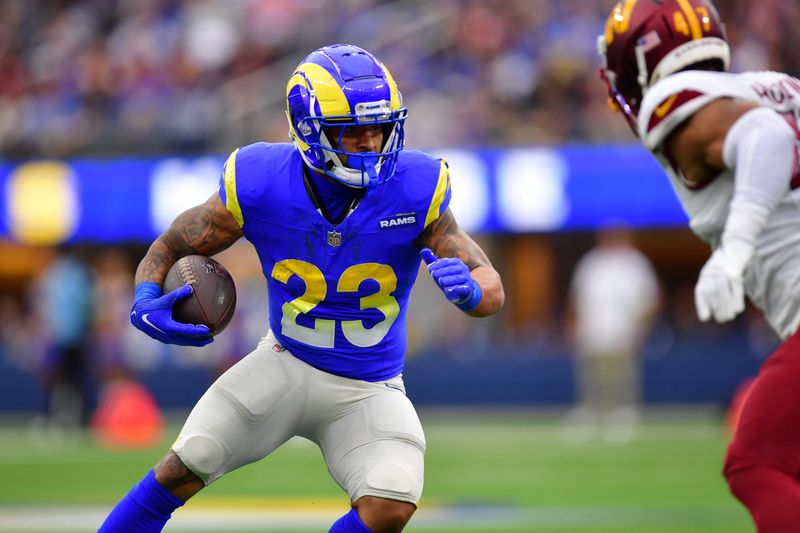 Dec 17, 2023; Inglewood, California, USA; Los Angeles Rams running back Kyren Williams (23) runs the ball against Washington Commanders linebacker Khaleke Hudson (47) during the first half at SoFi Stadium. Mandatory Credit: Gary A. Vasquez-USA TODAY Sports
