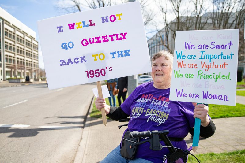Pat Doerfler protests during the International Women's Day march at the Oregon State Capitol on Saturday, March 8, 2024, in Salem, Ore.