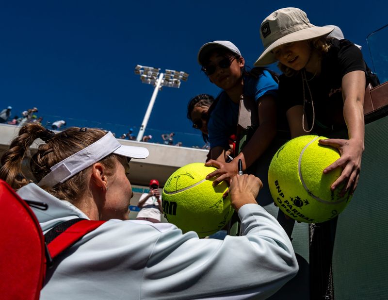Elena Rybakina signs autographs for fans after her third-round win over Katie Boulter at the BNP Paribas Open in Indian Wells, Calif., Sunday, March 9, 2025.