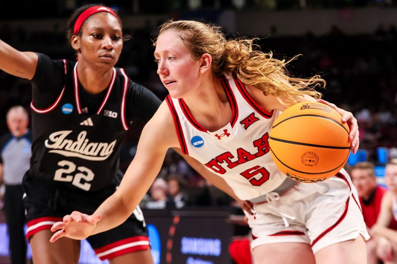 Mar 21, 2025; Columbia, South Carolina, USA; Utah Utes guard Gianna Kneepkens (5) drives past Indiana Hoosiers guard Chloe Moore-McNeil (22) in the second half at Colonial Life Arena. Mandatory Credit: Jeff Blake-Imagn Images