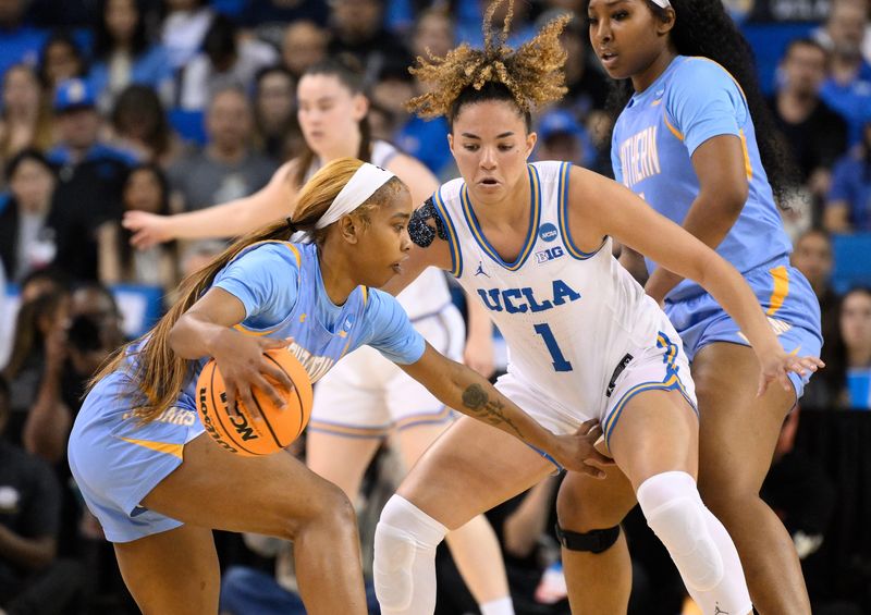Mar 21, 2025; Los Angeles, California, USA; Southern Lady Jaguars guard Aniya Gourdine (1) tries to dribble the ball around UCLA Bruins guard Kiki Rice (1) during the first quarter of an NCAA Tournament first-round game at Pauley Pavilion presented by Wescom. Mandatory Credit: Robert Hanashiro-Imagn Images