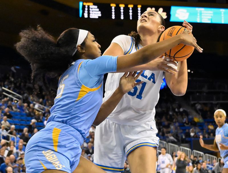 Mar 21, 2025; Los Angeles, California, USA; UCLA Bruins center Lauren Betts (51) is fouled by Southern Lady Jaguars forward Sky Castro (15) during the first quarter of an NCAA Tournament first-round game at Pauley Pavilion presented by Wescom. Mandatory Credit: Robert Hanashiro-Imagn Images