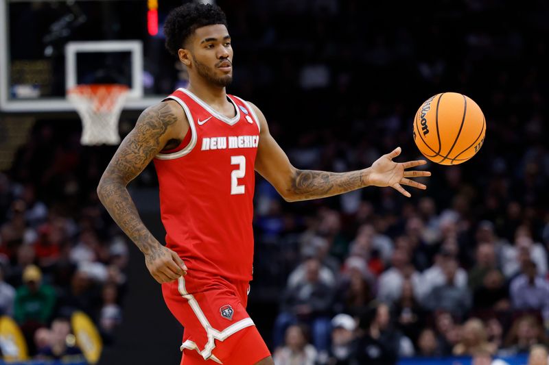 Mar 21, 2025; Cleveland, OH, USA; New Mexico Lobos guard Donovan Dent (2) plays the ball in the second half against the Marquette Golden Eagles during the NCAA Tournament First Round at Rocket Arena. Mandatory Credit: Rick Osentoski-Imagn Images
