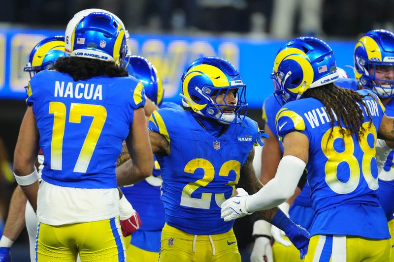 Dec 28, 2024; Inglewood, California, USA; Los Angeles Rams running back Kyren Williams (23) celebrates with wide receiver Jordan Whittington (88) and wide receiver Puka Nacua (17) after scoring on a 1-yard touchdown run against the Arizona Cardinals in the first half at SoFi Stadium. Mandatory Credit: Kirby Lee-Imagn Images