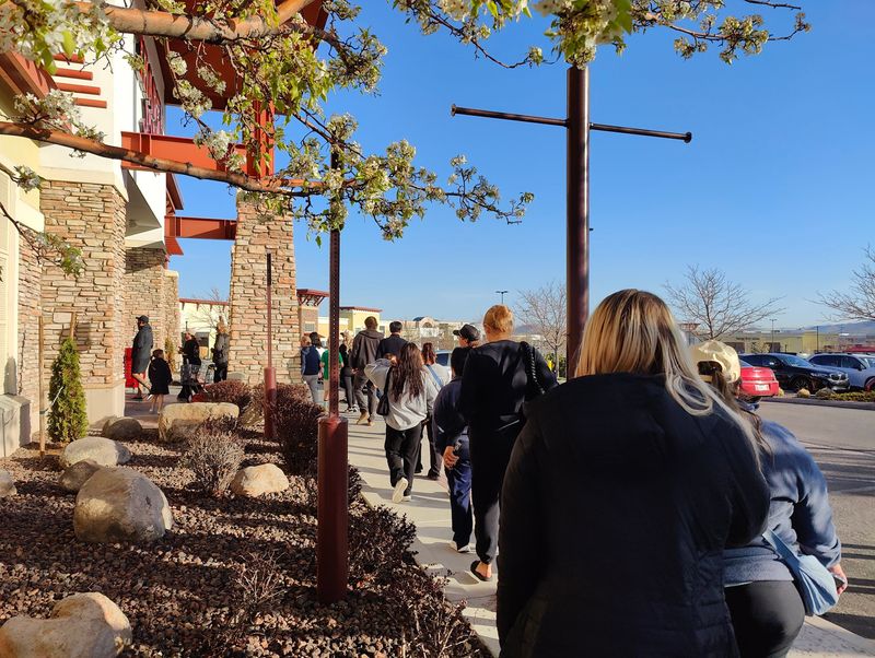 People line up at the Trader Joe's at the Shayden Summit mall in south Reno on April 9, 2025, during a restock of its viral mini canvas tote bags.