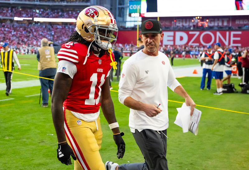 Dec 17, 2023; Glendale, Arizona, USA; San Francisco 49ers head coach Kyle Shanahan talks to wide receiver Brandon Aiyuk (11) against the Arizona Cardinals at State Farm Stadium. Mandatory Credit: Mark J. Rebilas-USA TODAY Sports