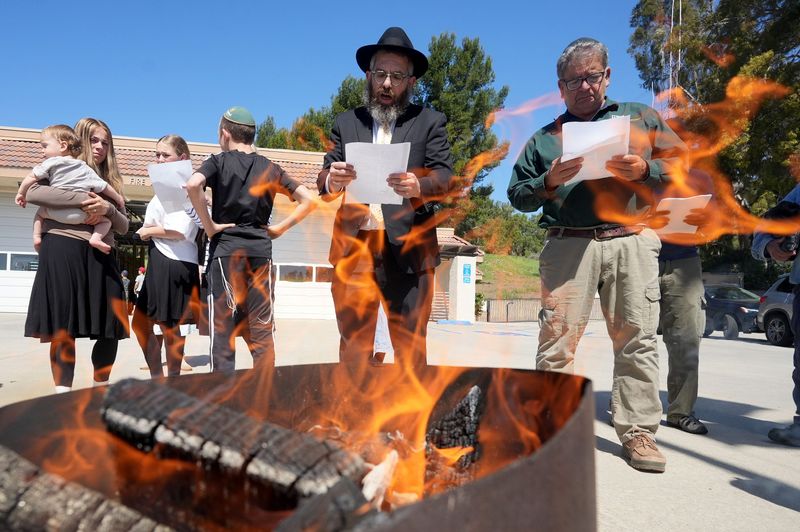 Rabbi Areyh Lang, from left, and Ed Sanchez pray during a bread burning ceremony Ventura County Fire Station No. 52 in Camarillo on April 11, 2025. The event prepares for the start of the Jewish holiday of Passover.