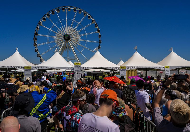 Festivalgoers wait to be let into a wristband scan point and security checkpoint before clearing the main gates at the Coachella Valley Music and Arts Festival in Indio, Calif., Friday, April 11, 2025.