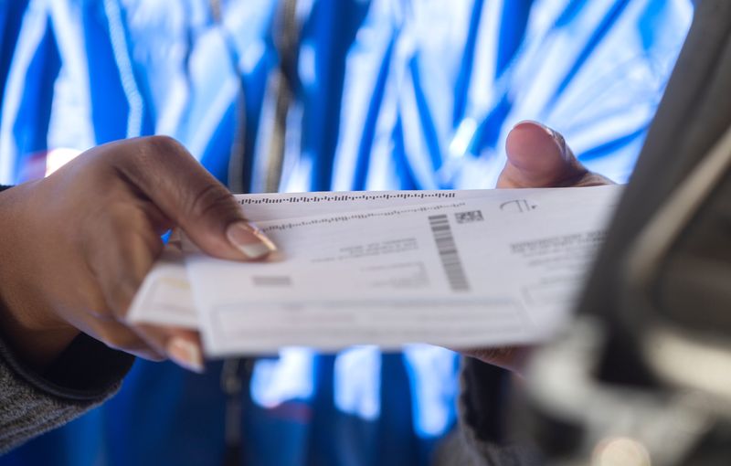 Election worker Jayla Thompson puts a completed ballot into a ballot box at the ballot drop-off point at the San Joaquin County Administration Building in downtown Stockton on Tuesday, Nov. 8, 2022.