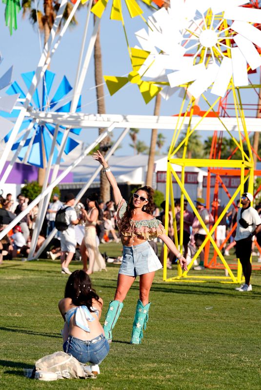 Festivalgoers take photographs with the art installation "Take Flight" by Isabel + Helen as the backdrop during the Coachella Valley Music and Arts Festival in Indio, Calif., on Sun., April 13, 2025.