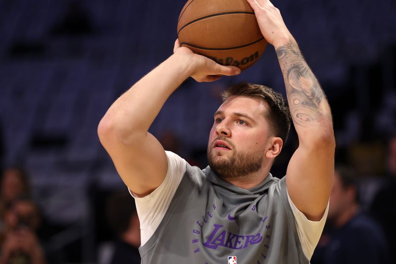 Apr 22, 2025; Los Angeles, California, USA; Los Angeles Lakers guard Luka Doncic (77) warms up before a game two of first round for the 2024 NBA Playoffs against the Minnesota Timberwolves at Crypto.com Arena. Mandatory Credit: Kiyoshi Mio-Imagn Images