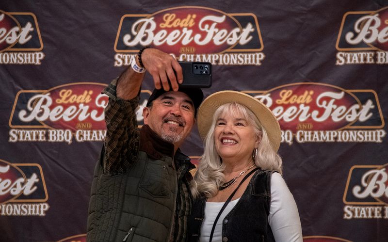 Al and Mary Correa of Manteca take a selfie at the Ole Mettler Grape Pavilion at the Lodi Grape Festival Grounds during the annual Lodi Beer Fest and State BBQ Championship on Apr. 26, 2025. About 50 local and national breweries and 30 BBQ teams participated in the event which draws thousands.