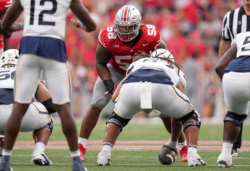 Aug 31, 2024; Columbus, OH, USA; Ohio State Buckeyes defensive tackle Ty Hamilton (58) lines up across from Akron Zips offensive lineman Delvin Morris (57) during the NCAA football game at Ohio Stadium. Ohio State won 52-6.