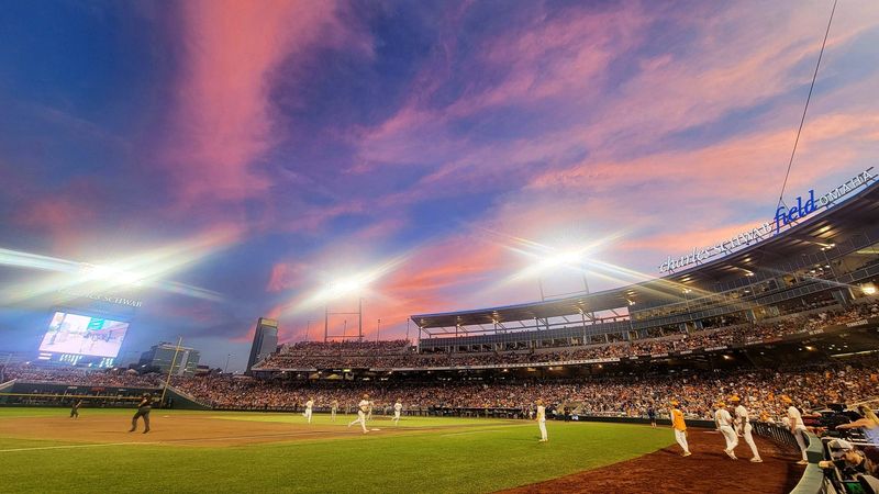 A cotton candy sky is seen from the third base photographers well during game one of the NCAA College World Series finals at Charles Schwab Field in Omaha, Neb., on Saturday, June 22, 2024.