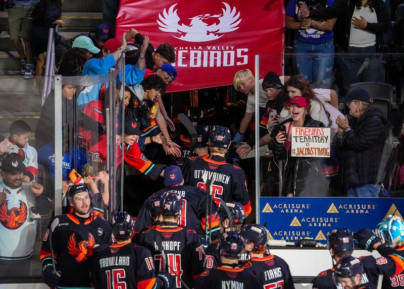 Coachella Valley Firebirds high-five fans as they head into the locker room after winning Game 2 of the Pacific Division semifinals in overtime at Acrisure Arena in Palm Desert, Calif., Saturday, May 3, 2025.