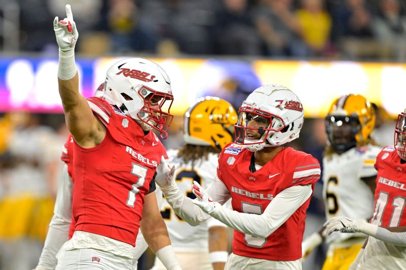 Dec 18, 2024; Inglewood, CA, USA; UNLV Rebels linebacker Jackson Woodard (7) and defensive back Cameron Oliver (5) celebrate after a play in the first half against the California Golden Bears at SoFi Stadium. Mandatory Credit: Jayne Kamin-Oncea-Imagn Images