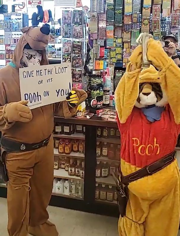The Lone Stranger and Sidekick walk away from Bob's Liquors in Redding with the "loot" on May 13, 2025. The mock robbery takes place each year during Redding Rodeo Week.