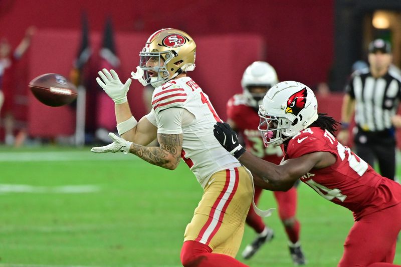 Jan 5, 2025; Glendale, Arizona, USA; San Francisco 49ers wide receiver Ricky Pearsall (14) catches a pass as Arizona Cardinals cornerback Starling Thomas V (24) defends in the second half at State Farm Stadium. Mandatory Credit: Matt Kartozian-Imagn Images