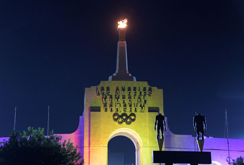 Sep 12, 2017; Los Angeles, CA, USA; General overall view of the Los Angeles Memorial Coliseum and Olympic torch illuminated in the colors of the LA2028 logo to commemorate the awarding of the 2028 Olympics and Paralympics to Los Angeles. Mandatory Credit: Kirby Lee-USA TODAY Sports