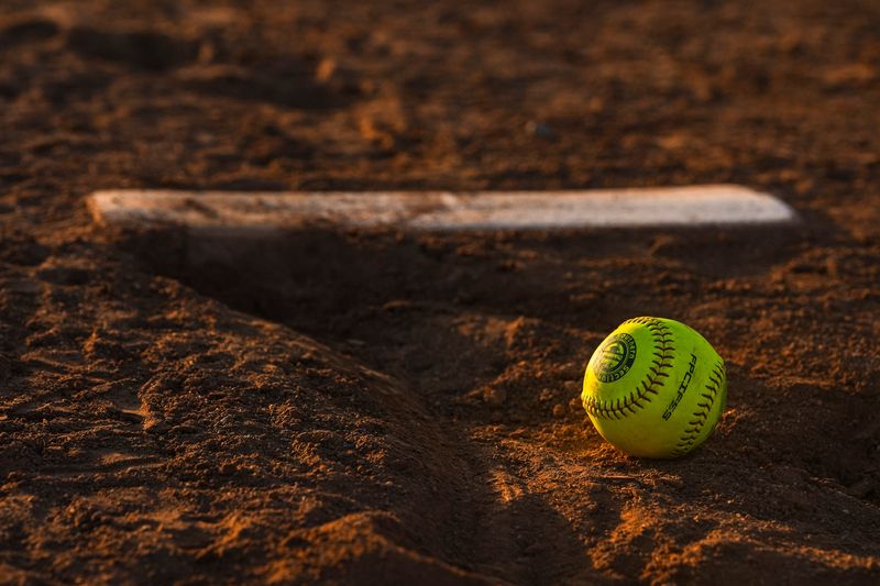 A CIF softball is seen resting in the dirt in front of the pitcher's rubber after a CIF-SS Division 4 quarterfinal game in Indio, Calif., Wednesday, May 21, 2025.