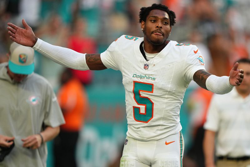 Nov 19, 2023; Miami Gardens, Florida, USA; Miami Dolphins cornerback Jalen Ramsey (5) celebrates after his interception against the Las Vegas Raiders during the second half at Hard Rock Stadium. Mandatory Credit: Jasen Vinlove-USA TODAY Sports
