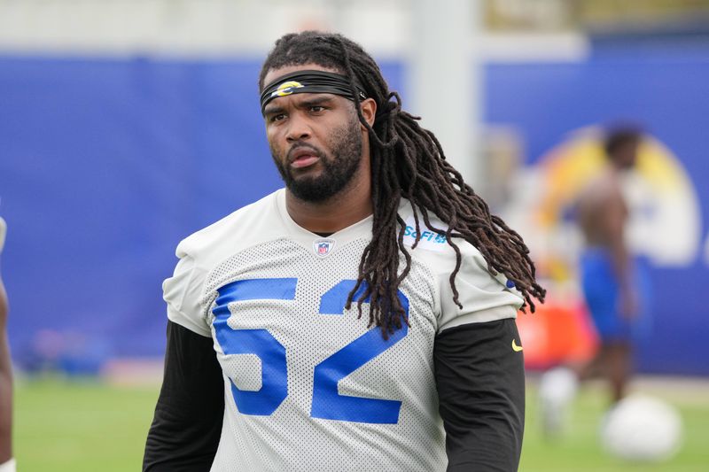 May 28, 2025; Woodland Hills, CA, USA; Los Angeles Rams defensive end Larrell Murchison (52) takes a break and watches drills during organized team activities at Rams Practice Facility. Mandatory Credit: Kirby Lee-Imagn Images