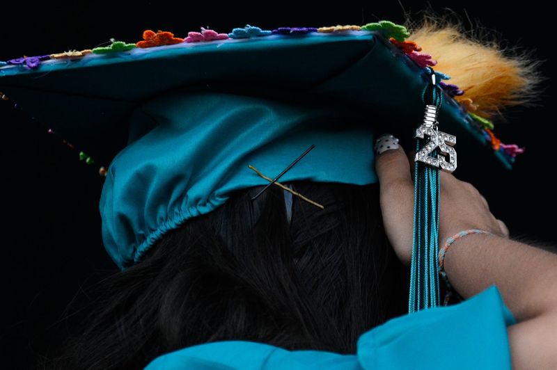 A graduate holds up their cap during the Sultana High School Commencement Ceremony on Tuesday, May 27, 2025 at Glen Helen Amphitheater in San Bernardino.