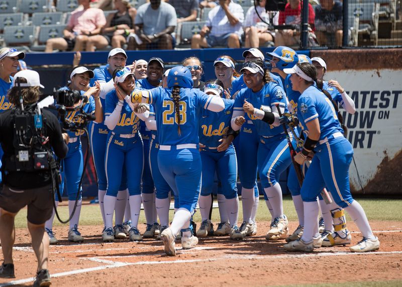 Jun 1, 2025; Oklahoma City, OK, USA; UCLA Bruins players celebrate catcher Alexis Ramirez (28) home run in the second inning against the Tennessee Lady Volunteers during the NCAA Softball Women's College World Series at Devon Park. Mandatory Credit: Brett Rojo-Imagn Images