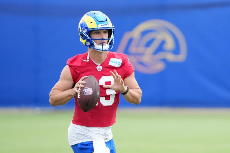 Jun 3, 2025; Woodland Hills, CA, USA; Los Angeles Rams quarterback Stetson Bennett (13) throws the ball during organized team activities at Rams Practice Facility. Mandatory Credit: Kirby Lee-Imagn Images