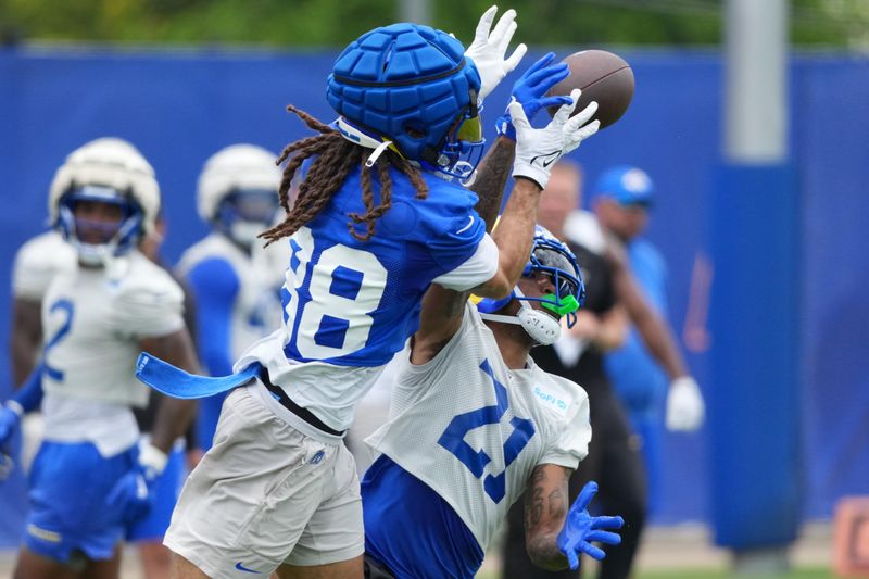 Jun 3, 2025; Woodland Hills, CA, USA; Los Angeles Rams cornerback Charles Woods (21) deflects a pass against receiver Jordan Whittington (88) during organized team activities at Rams Practice Facility. Mandatory Credit: Kirby Lee-Imagn Images