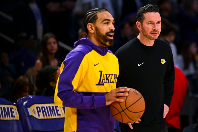 Mar 20, 2025; Los Angeles, California, USA; Los Angeles Lakers guard Gabe Vincent (7) talks with Los Angeles Lakers head coach JJ Redick before the game against the Milwaukee Bucksat Crypto.com Arena. Mandatory Credit: Jonathan Hui-Imagn Images