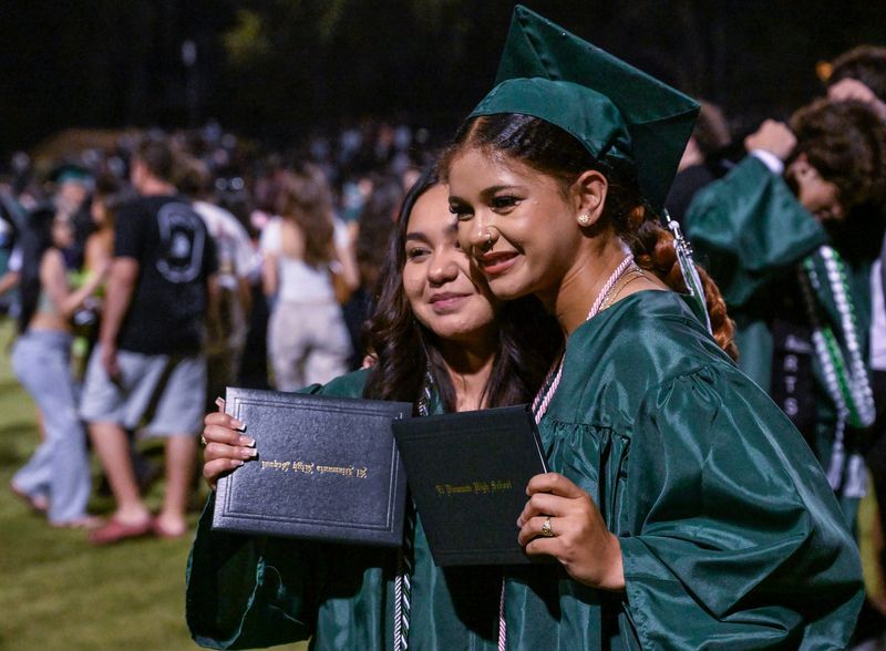 El Diamante graduates Cheri Magnano, right, and Samantha Sanchez pose for pictures after their High School Commencement Ceremony on Thursday, June 5, 2025.