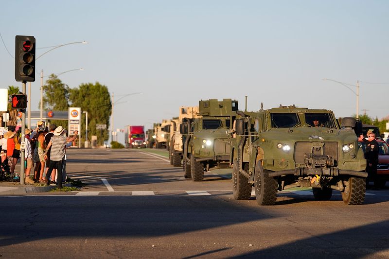 A convoy of Marines en route to the greater Los Angeles area pass Park Boulevard along Highway 62 in Joshua Tree, Calif., on June 9, 2025.