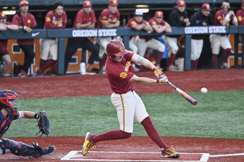May 31, 2025; Corvallis, OR, USA; USC infielder Ethan Hedges (15) hits the ball in the seventh inning against Saint Mary's at the NCAA Corvallis Regional at Goss Stadium. Mandatory Credit: Troy Wayrynen-Imagn Images