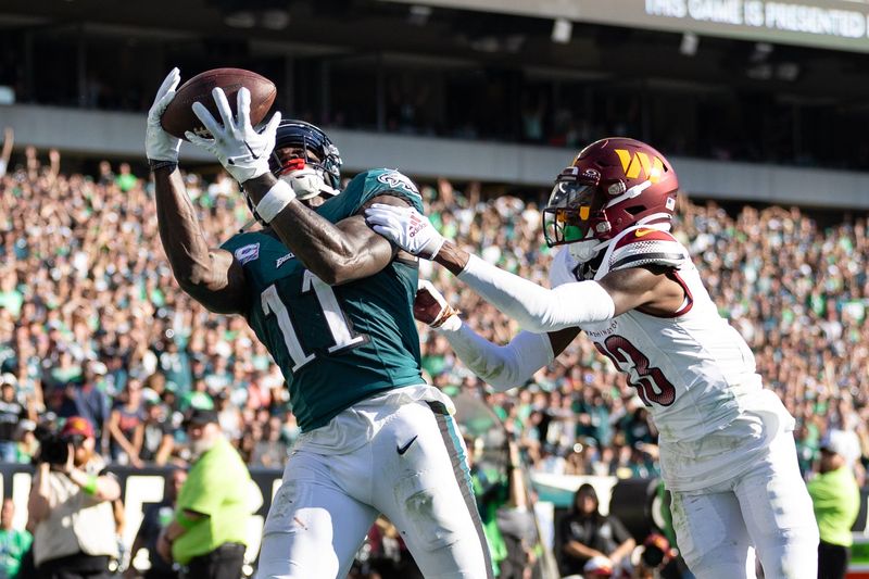 Oct 1, 2023; Philadelphia, Pennsylvania, USA; Philadelphia Eagles wide receiver A.J. Brown (11) catches a touchdown pass past Washington Commanders cornerback Emmanuel Forbes (13) during the fourth quarter at Lincoln Financial Field. Mandatory Credit: Bill Streicher-USA TODAY Sports