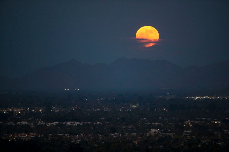 The strawberry moon, the first full moon of summer, rises above the Santa Rosa mountains looking east from Palm Springs, California, on June 21, 2024. This moon was named because ripe strawberries were ready to be gathered around this time.