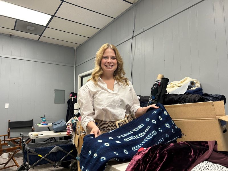 Redding Fashion Alliance Executive Director Abigail Young holds a piece of wool material at RFA's Fashion Fabric Boutique in Redding on June 13,2025. The new retail boutique is expected to open this summer.