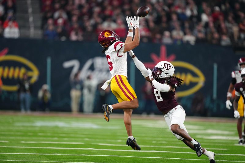 Dec 27, 2024; Las Vegas, NV, USA; Southern California Trojans wide receiver Makai Lemon (6) catches the ball against Texas A&M Aggies defensive back Jaydon Hill (8) in the second half at Allegiant Stadium. Mandatory Credit: Kirby Lee-Imagn Images