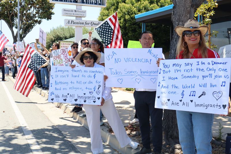 Salinas, Calif. on the nationwide "No Kings Day of Defiance" June 14, 2025. Crowds lined South Main St. from Blanco Road to San Miguel Ave, waving American flags, holding protest signs, and chanting words of protest to passing motorists, many honking in support.