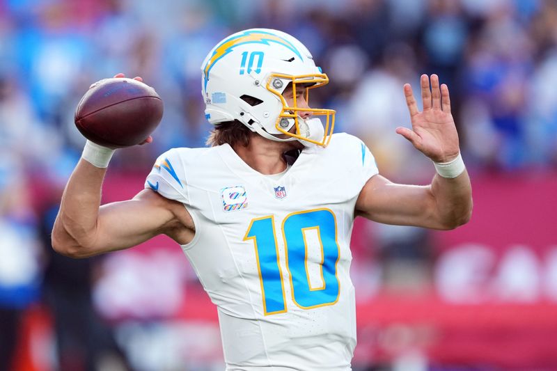 Oct 21, 2024; Glendale, Arizona, USA; Los Angeles Chargers quarterback Justin Herbert (10) warms up before facing the Arizona Cardinals at State Farm Stadium. Mandatory Credit: Joe Camporeale-Imagn Images