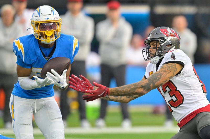 Dec 15, 2024; Inglewood, California, USA; Los Angeles Chargers cornerback Tarheeb Still (29) intercepts a pass intended for Tampa Bay Buccaneers wide receiver Mike Evans (13) in the first half at SoFi Stadium. Mandatory Credit: Jayne Kamin-Oncea-Imagn Images