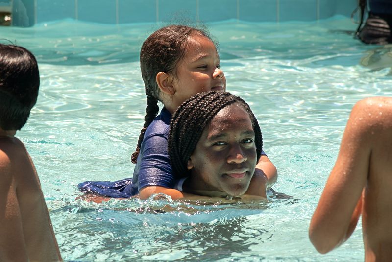 Five-year-old Aiden Lopez and his aunt Ohasiia Walker, 13, cool off in the newly renovated McKinley Park pool during the pools grand reopening in south Stockton on Jun. 17 2025