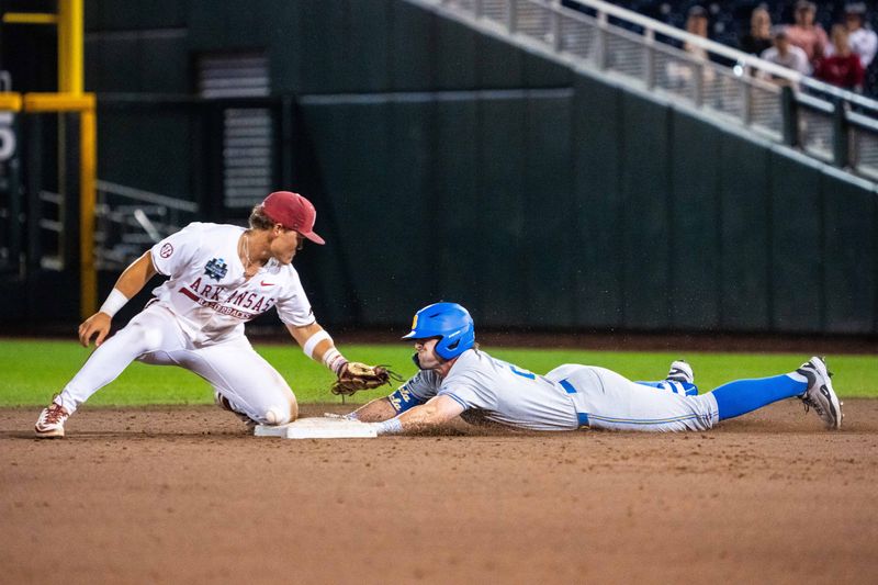 Jun 17, 2025; Omaha, Neb, USA; UCLA Bruins right fielder A.J. Salgado (24) slides to second after hitting an RBI double in the 9th at Charles Schwab Field. Mandatory Credit: Dylan Widger-Imagn Images