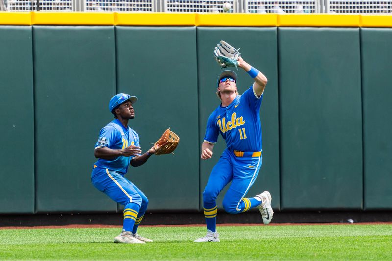 Jun 14, 2025; Omaha, Neb, USA; UCLA Bruins center fielder Payton Brennan (11) catches for an out against the Murray State Racers during the sixth inning at Charles Schwab Field. Mandatory Credit: Dylan Widger-Imagn Images