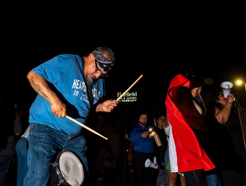 Jack Rosales of Indio plays a drum during the "ICE Melts in the Desert" protest in Indio, Calif., Wednesday, June 18, 2025.
