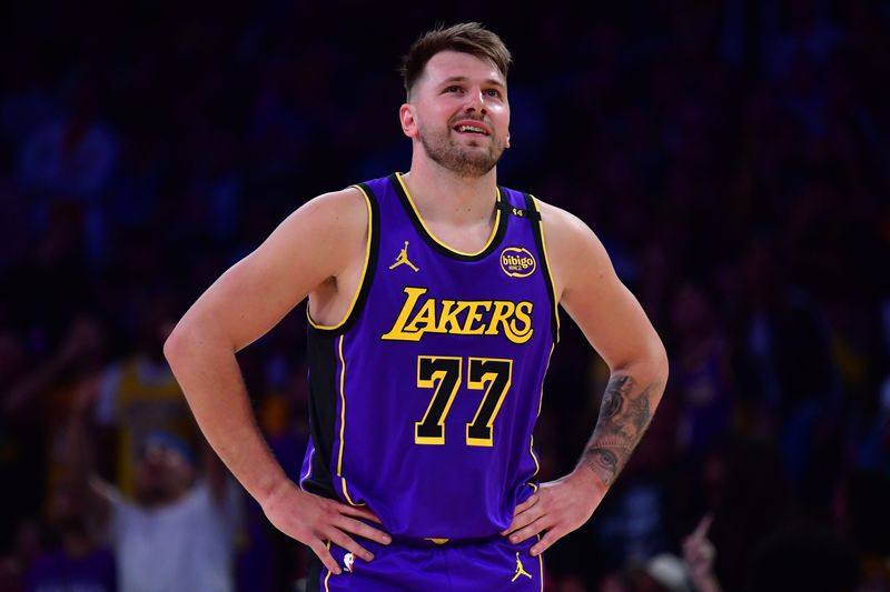 Feb 25, 2025; Los Angeles, California, USA; Los Angeles Lakers guard Luka Doncic (77) reacts against the Dallas Mavericks during the first quarter at Crypto.com Arena. Mandatory Credit: Gary A. Vasquez-Imagn Images