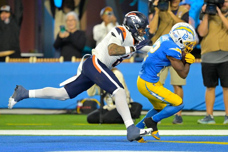 Dec 19, 2024; Inglewood, California, USA; Los Angeles Chargers wide receiver Derius Davis (12) hangs on to a touchdown pass as he is defended by Denver Broncos safety P.J. Locke (6) in the second half at SoFi Stadium. Mandatory Credit: Jayne Kamin-Oncea-Imagn Images
