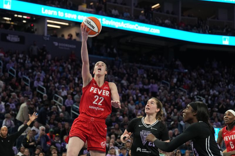 Jun 19, 2025; San Francisco, California, USA; Indiana Fever guard Caitlin Clark (22) scores against Golden State Valkyries guard Kate Martin (center right) and forward Laeticia Amihere (right) during the third quarter at Chase Center. Mandatory Credit: Darren Yamashita-Imagn Images