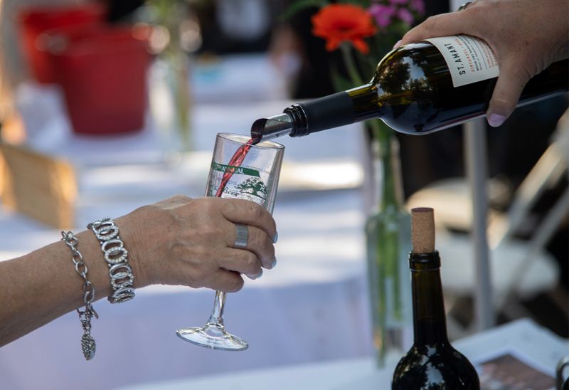 Wine is poured at the St. Amant Winery table at the Pixie Woods Wine and Beer tasting fundraiser at the children’s fantasy amusement park in Stockton on June 20 2025. The Lodi Wine Festival takes place March 28, at the Ole Mettler Grape Pavilion at the Lodi Grape Festival Grounds.
